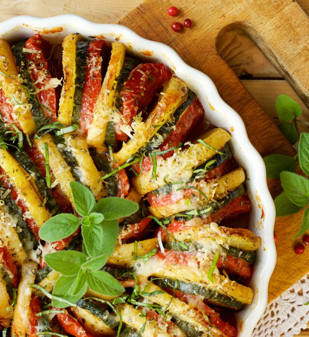 Vegetarian dish with organic roasted vegetables: potatoes, tomatoes and zucchini